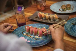 Plated sushi on dinner table.